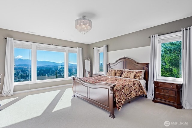 bedroom featuring a mountain view, visible vents, a chandelier, and carpet flooring