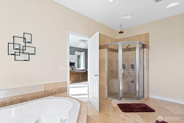 full bathroom with baseboards, ensuite bath, a stall shower, and a whirlpool tub