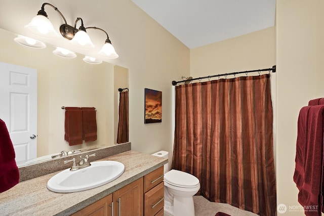 bathroom with vanity, toilet, a shower with curtain, and tile patterned flooring