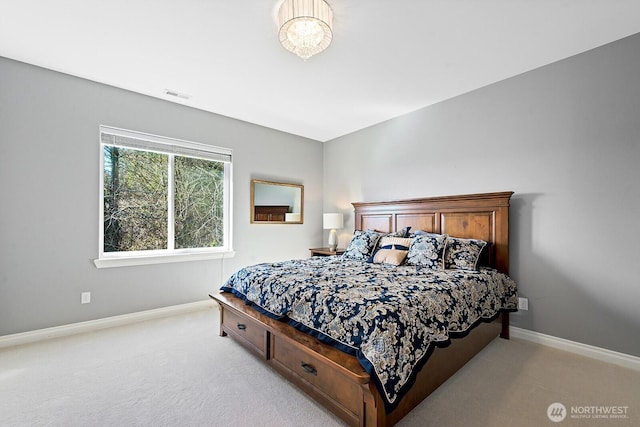 bedroom with light carpet, visible vents, and baseboards