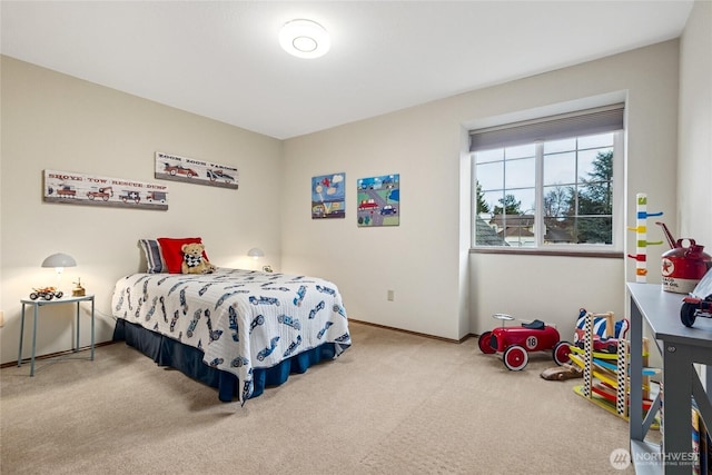 bedroom with baseboards and carpet