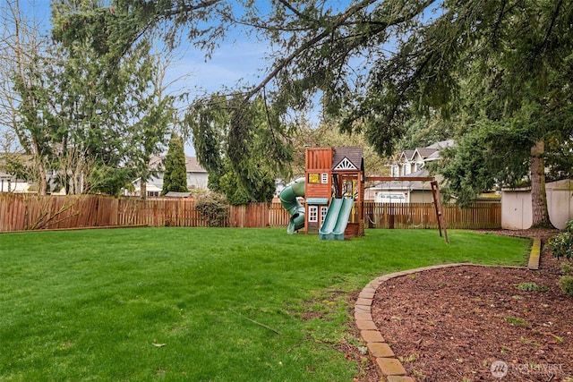 view of yard featuring a fenced backyard and a playground