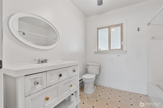 bathroom featuring tub / shower combination, toilet, vanity, and baseboards