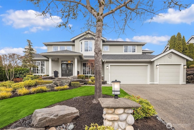 view of front of house with aphalt driveway, a shingled roof, and a front lawn