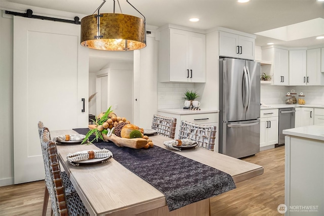 kitchen with light countertops, freestanding refrigerator, light wood-style floors, white cabinetry, and open shelves