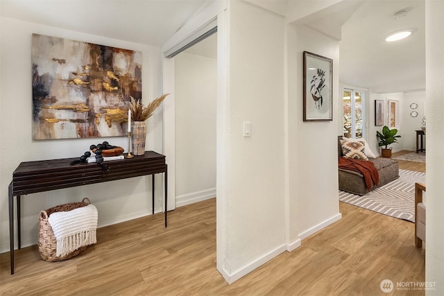 hall with wood finished floors and baseboards