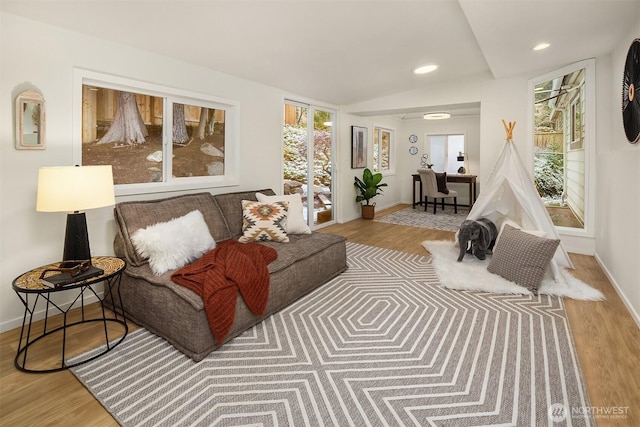 sitting room with plenty of natural light and wood finished floors