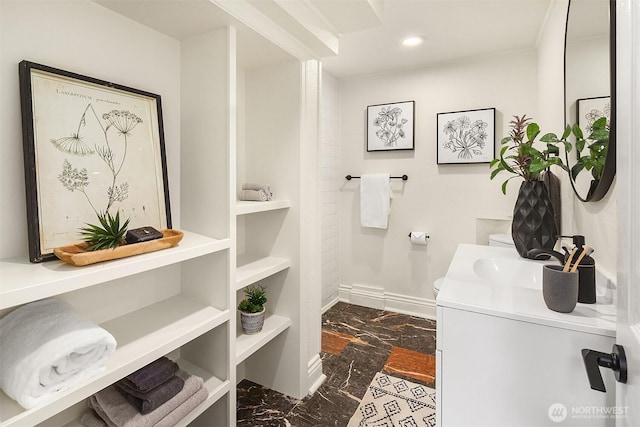 bathroom with vanity, baseboards, recessed lighting, toilet, and marble finish floor