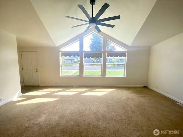 carpeted empty room featuring ceiling fan, baseboards, and high vaulted ceiling