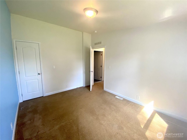 unfurnished bedroom with visible vents, baseboards, and carpet floors