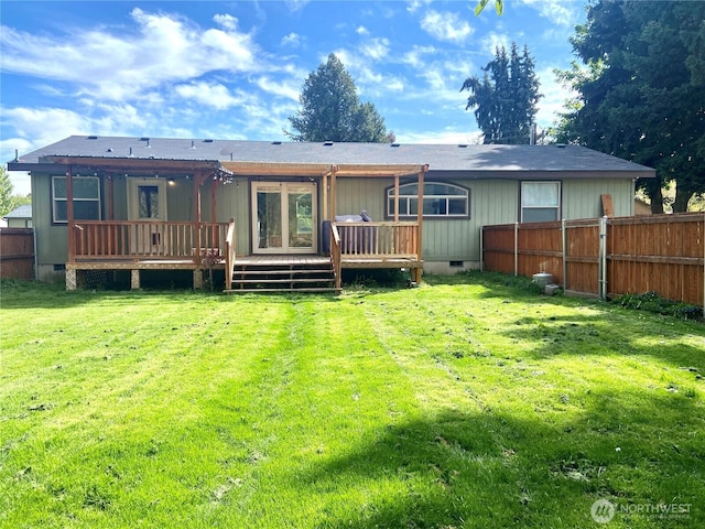 rear view of property featuring a wooden deck, a yard, fence, and crawl space