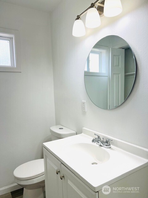 bathroom featuring toilet and vanity