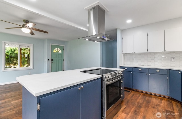 kitchen featuring blue cabinets, island exhaust hood, stainless steel electric stove, and decorative backsplash