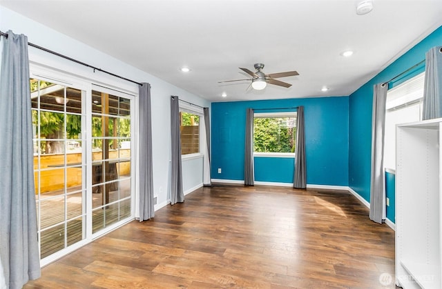 empty room with recessed lighting, a ceiling fan, baseboards, and wood finished floors