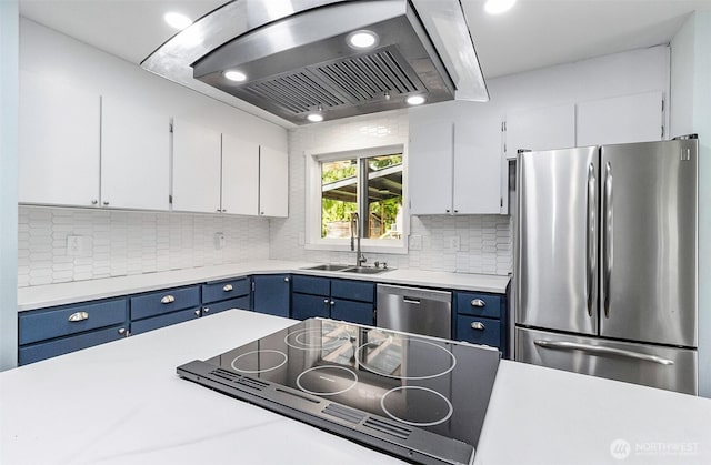 kitchen with blue cabinetry, a sink, range hood, stainless steel appliances, and light countertops