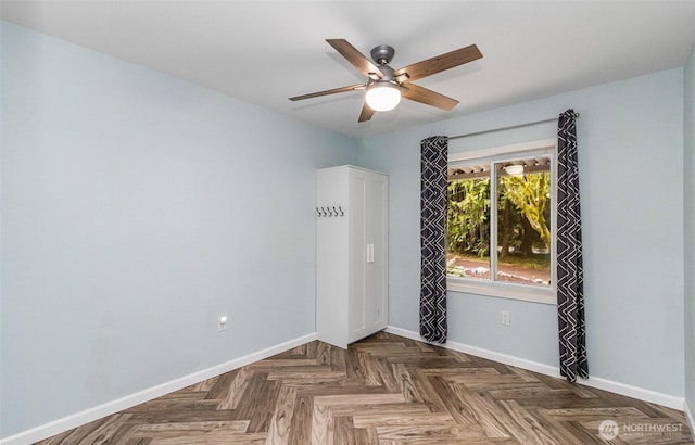 unfurnished room featuring baseboards and ceiling fan