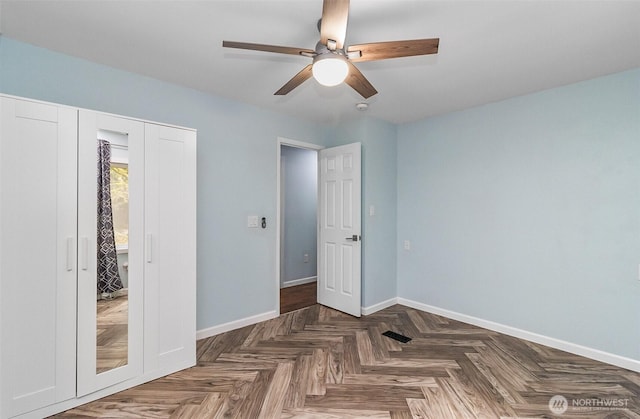 bedroom with a closet, a ceiling fan, and baseboards