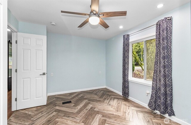 empty room with recessed lighting, a ceiling fan, and baseboards