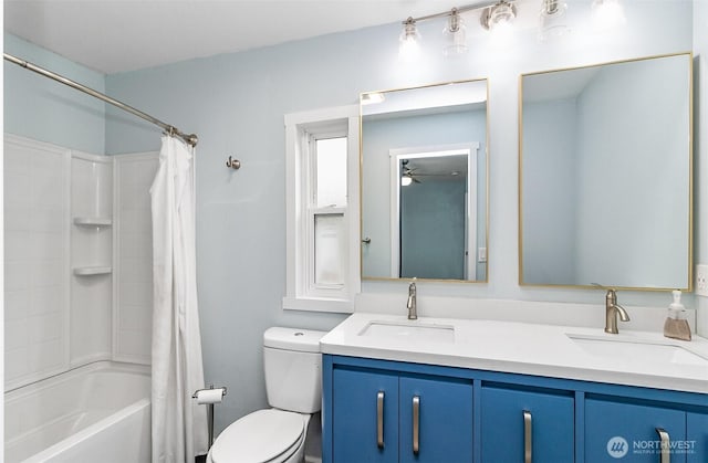 bathroom featuring double vanity, toilet, shower / bath combo with shower curtain, and a sink