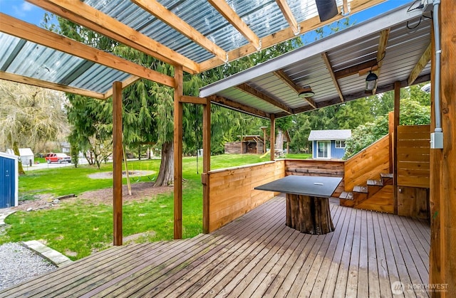 deck featuring an outdoor structure and a yard