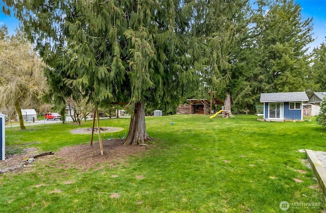 view of yard featuring an outbuilding and a playground