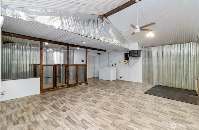 finished basement featuring wood finished floors, washing machine and dryer, and a ceiling fan