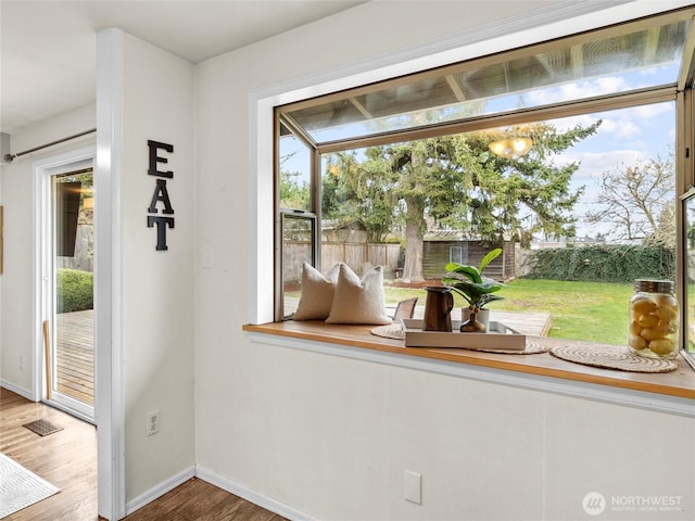 entryway featuring a wealth of natural light, baseboards, and wood finished floors