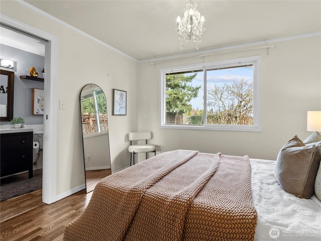 bedroom featuring crown molding, a notable chandelier, wood finished floors, and baseboards