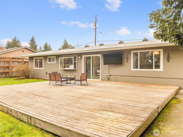 back of house featuring a deck and fence