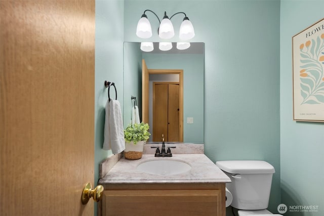 bathroom featuring vanity and toilet