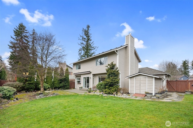 rear view of property featuring fence, a chimney, entry steps, a patio area, and a lawn