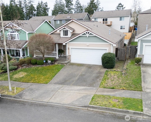 view of front facade with a front lawn, fence, covered porch, concrete driveway, and a garage