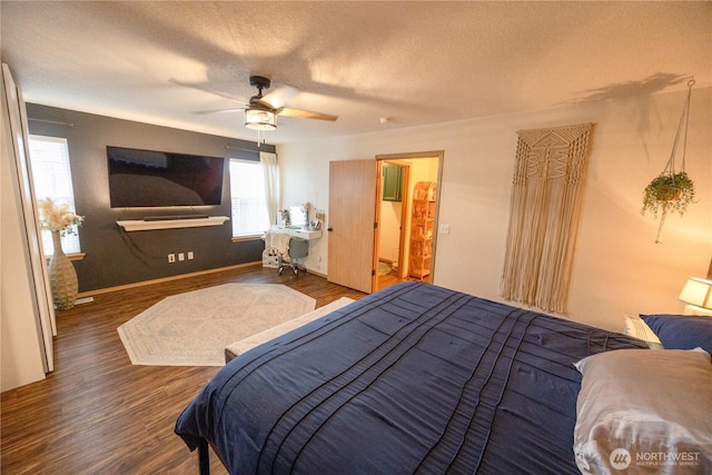 bedroom featuring baseboards, a textured ceiling, a ceiling fan, and wood finished floors