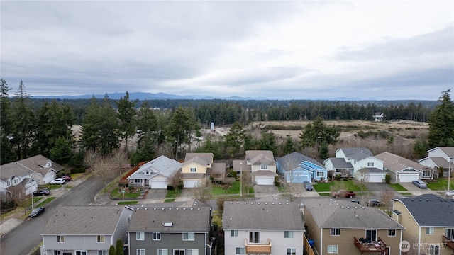 drone / aerial view featuring a residential view and a view of trees