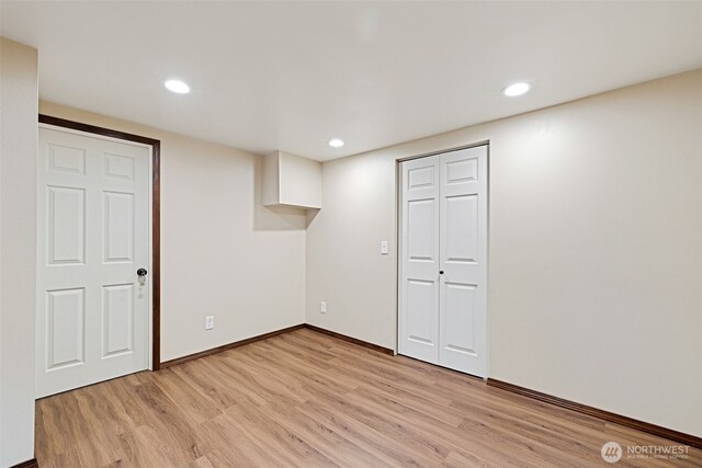 spare room with recessed lighting, light wood-type flooring, and baseboards