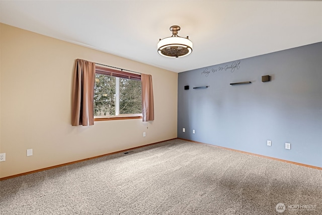 spare room with baseboards and carpet floors