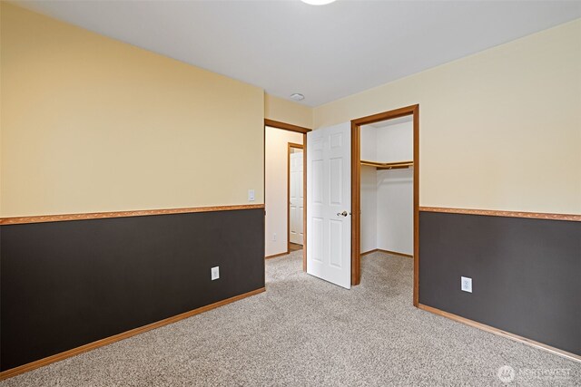 spare room featuring baseboards and carpet flooring