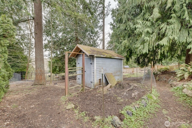 view of outbuilding with an outbuilding and fence