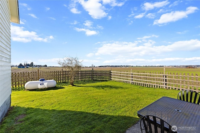 view of yard with a rural view and fence