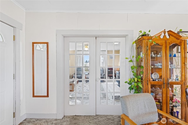 entryway with crown molding, carpet flooring, and french doors