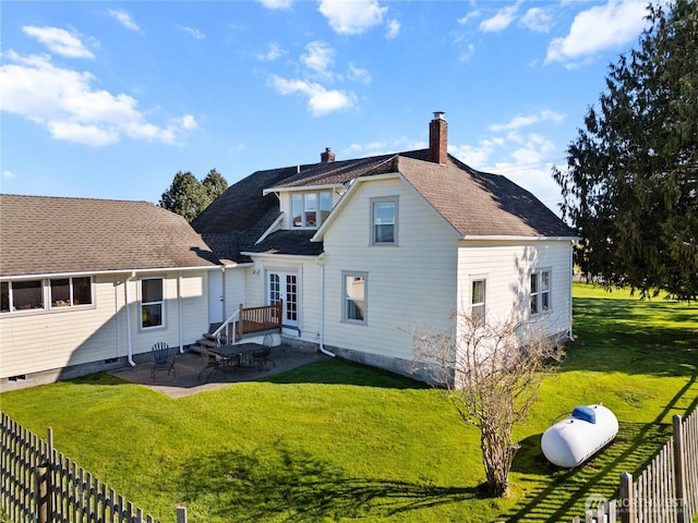 back of house with a patio area, a yard, a chimney, and fence