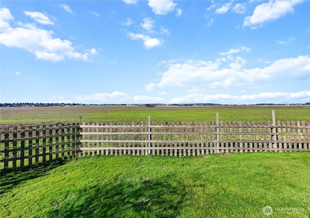 view of yard featuring a rural view and fence