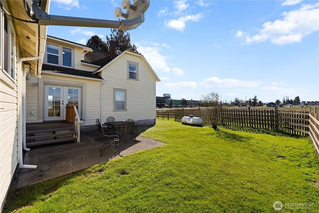 view of yard featuring a patio area, french doors, and fence private yard