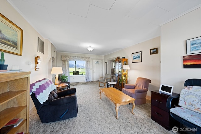 living area featuring visible vents, carpet floors, and crown molding