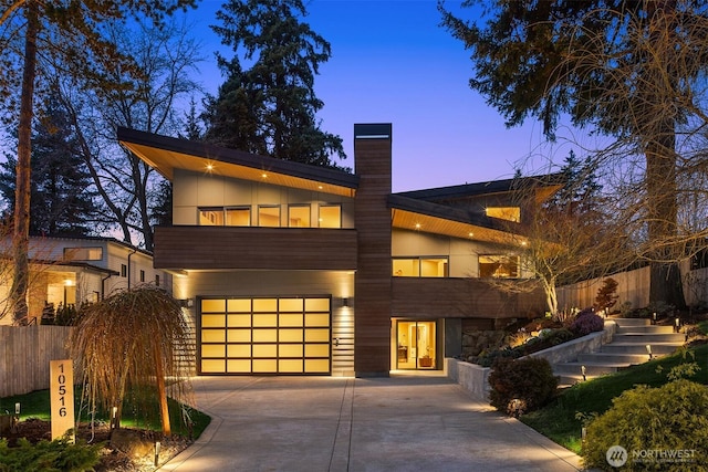 contemporary home featuring driveway and a chimney