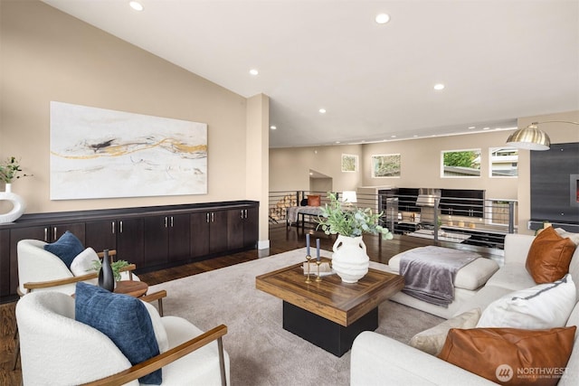 living area featuring recessed lighting, wood finished floors, and vaulted ceiling