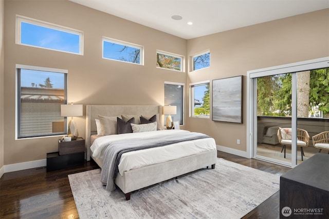 bedroom featuring baseboards, recessed lighting, a towering ceiling, access to outside, and dark wood-style flooring