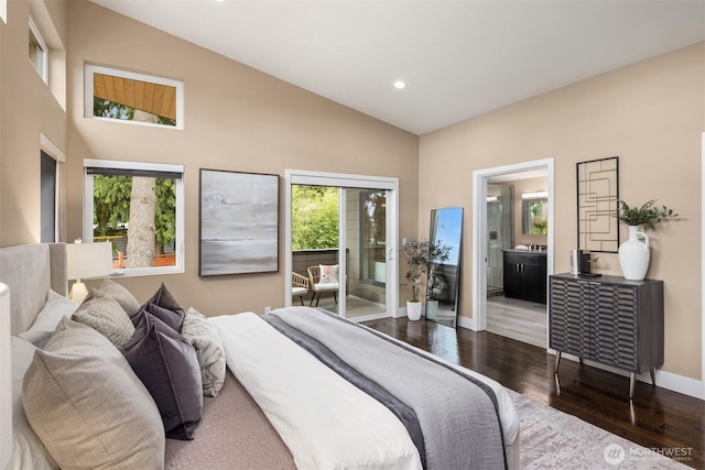 bedroom with access to exterior, multiple windows, wood finished floors, and vaulted ceiling