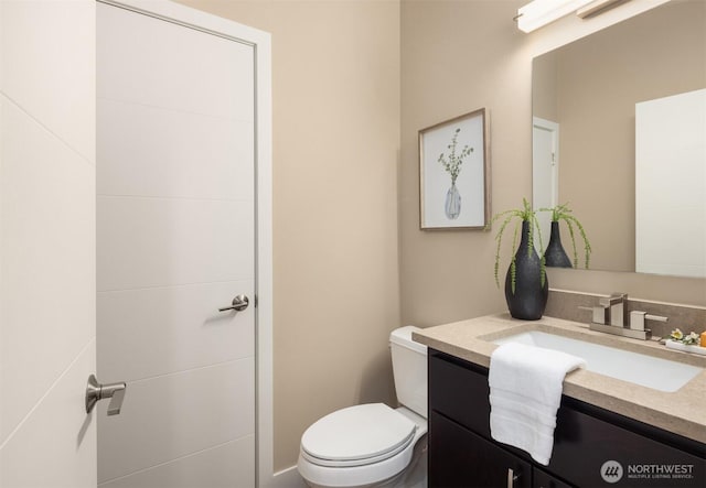 bathroom with toilet and vanity