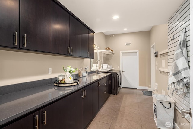 kitchen with visible vents, baseboards, light tile patterned floors, recessed lighting, and separate washer and dryer